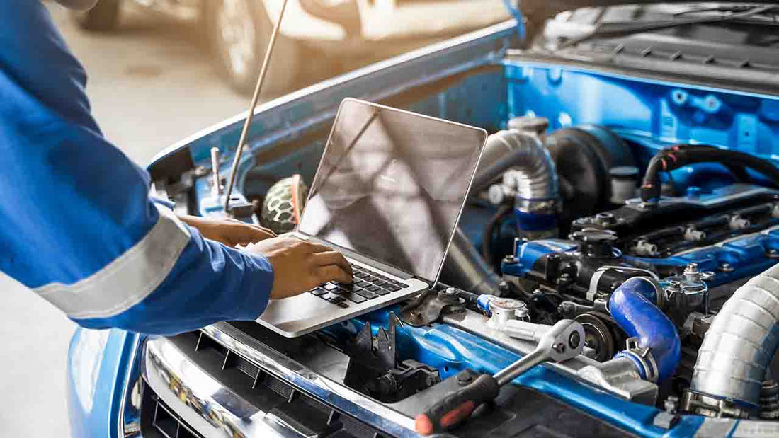 
An image displays a auto mechanical at a repair shop.